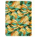 A painterly pattern of ripe bananas (in goldenrod yellow and burnt orange) pops against a seafoam teal background, layered with tropical palm leaves of deep forest and muted olive green. Contact us with accessibility feedback, we'd love to help!